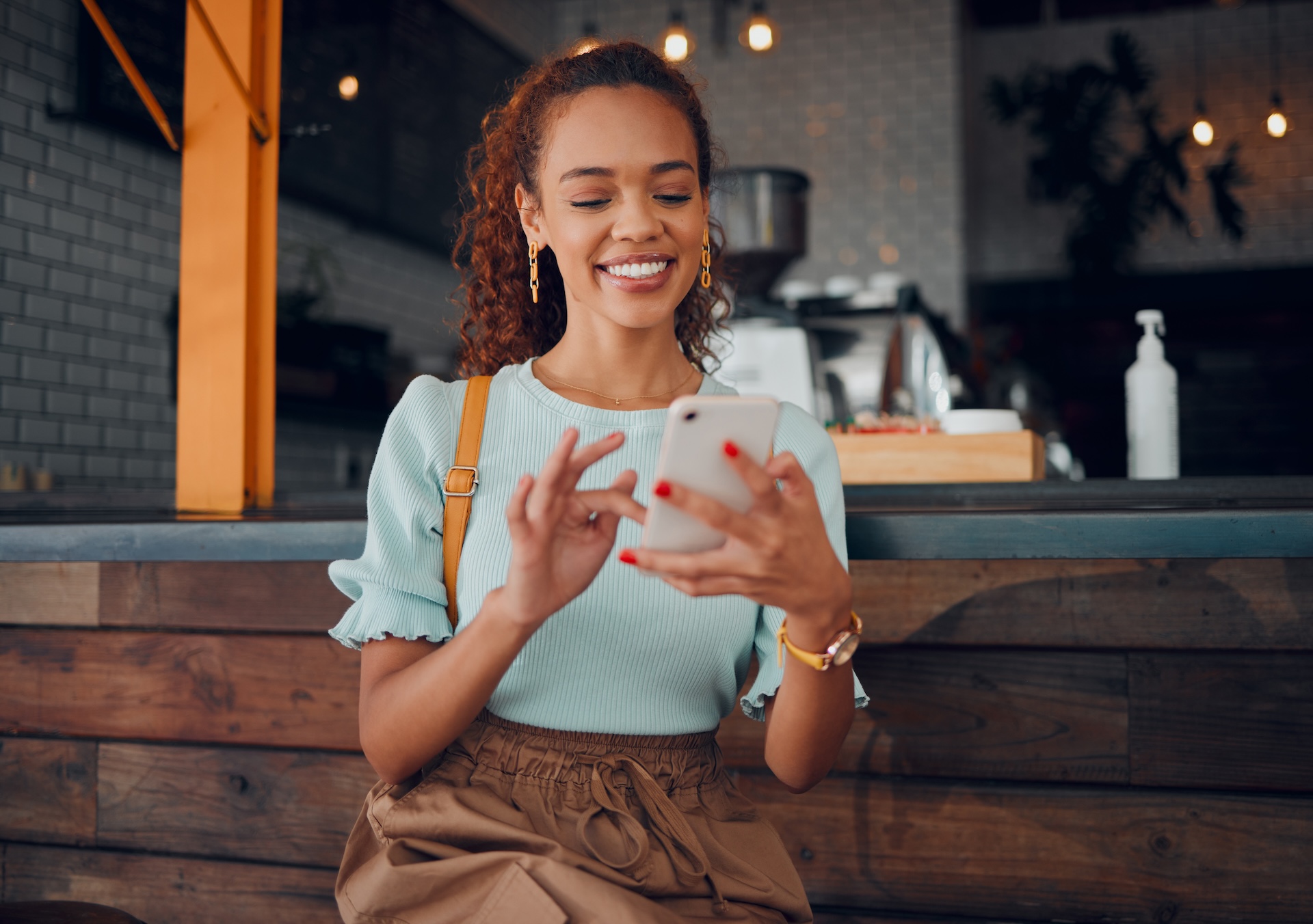 Restaurant, smartphone and relaxed black woman typing, scrolling on her phone