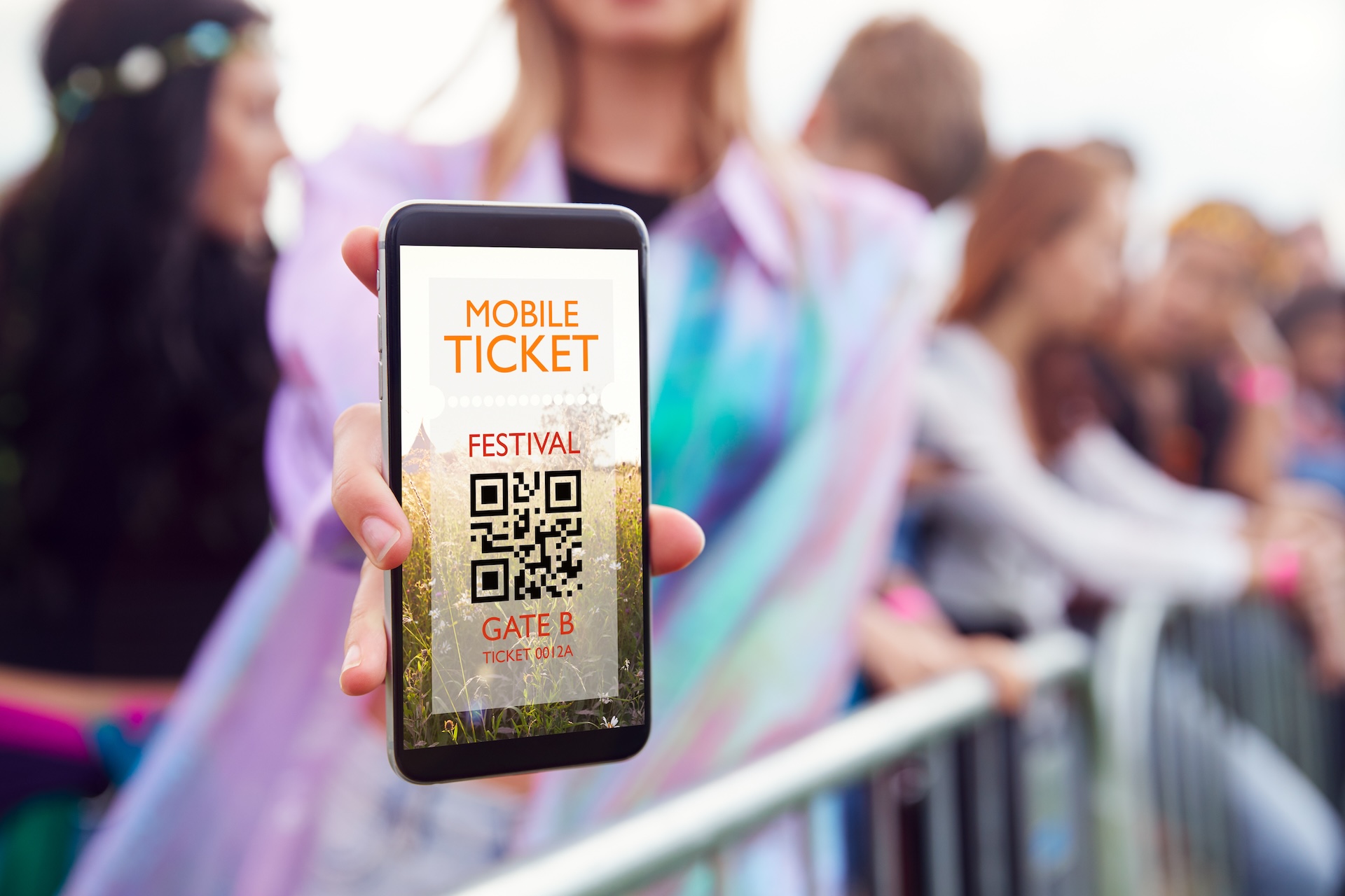 Woman Holding Mobile Ticket As She Arrives At A Music Festival