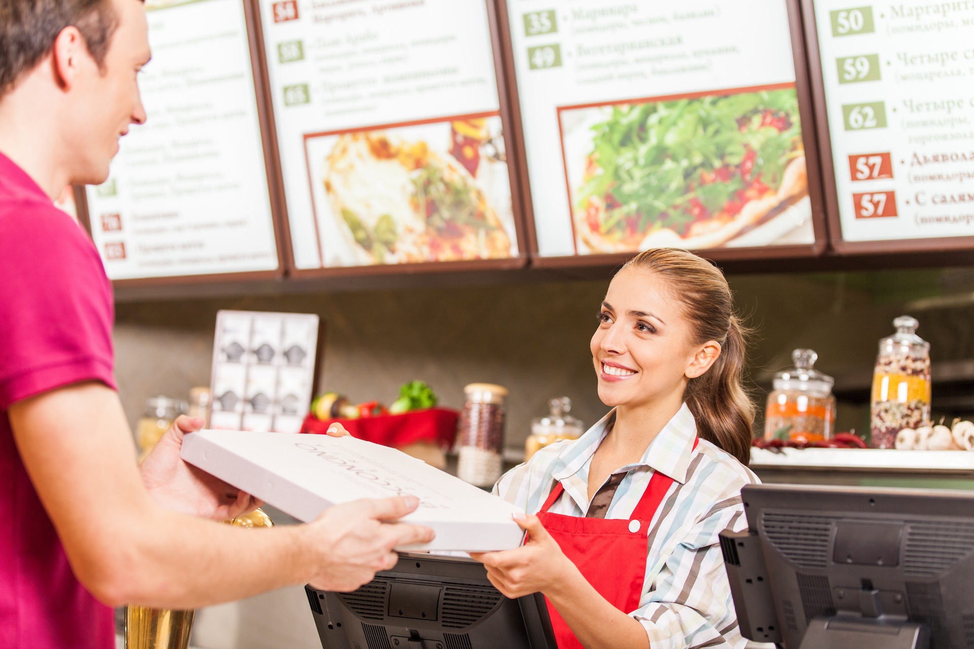 Quick Service Restaurant worker serving food with smile