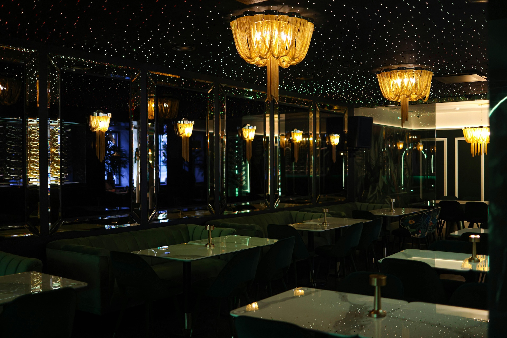 a darkened bar with stars on the ceiling