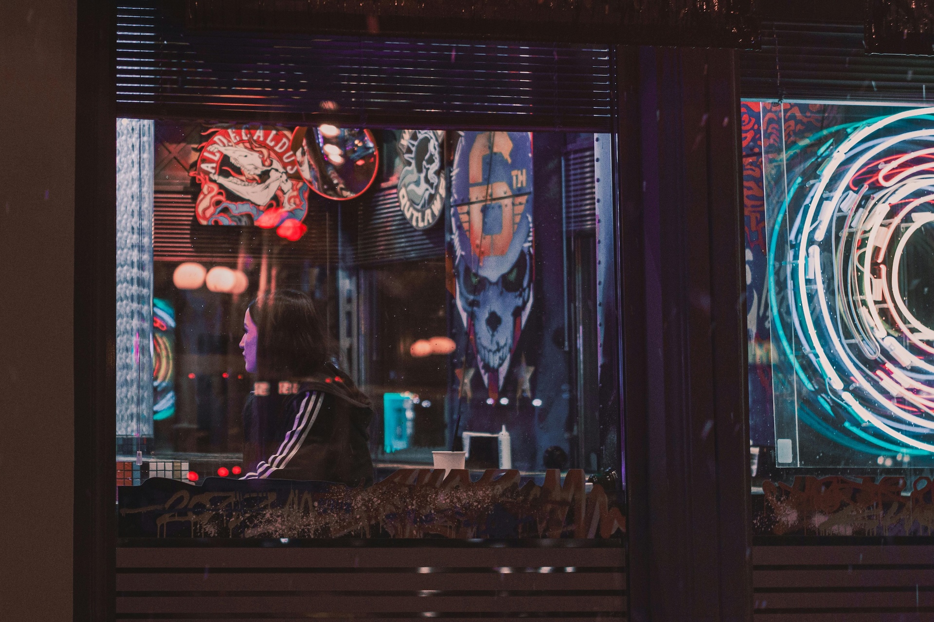 window in a bar with a colorful mural inside