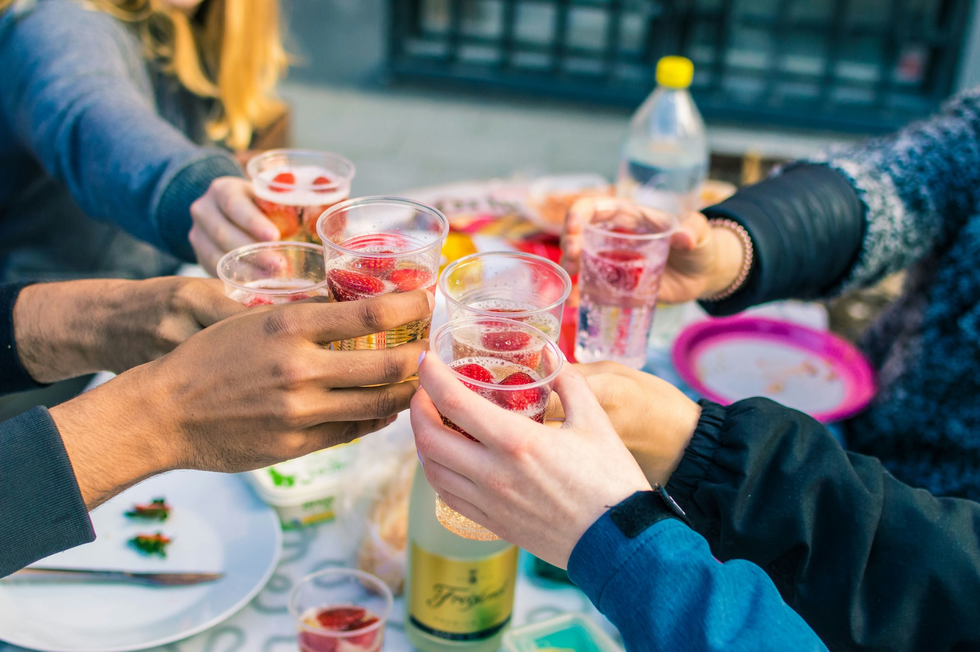 group of friends holding cocktails