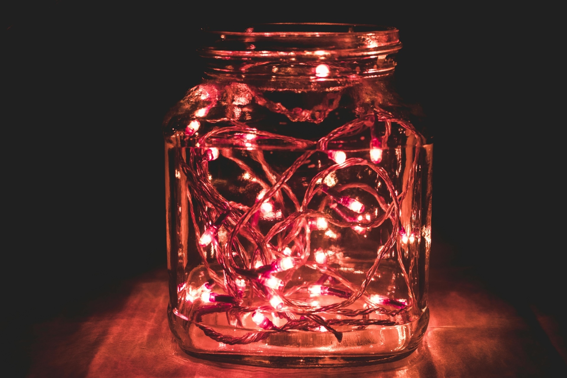 red fairy lights in a jar as bar decor