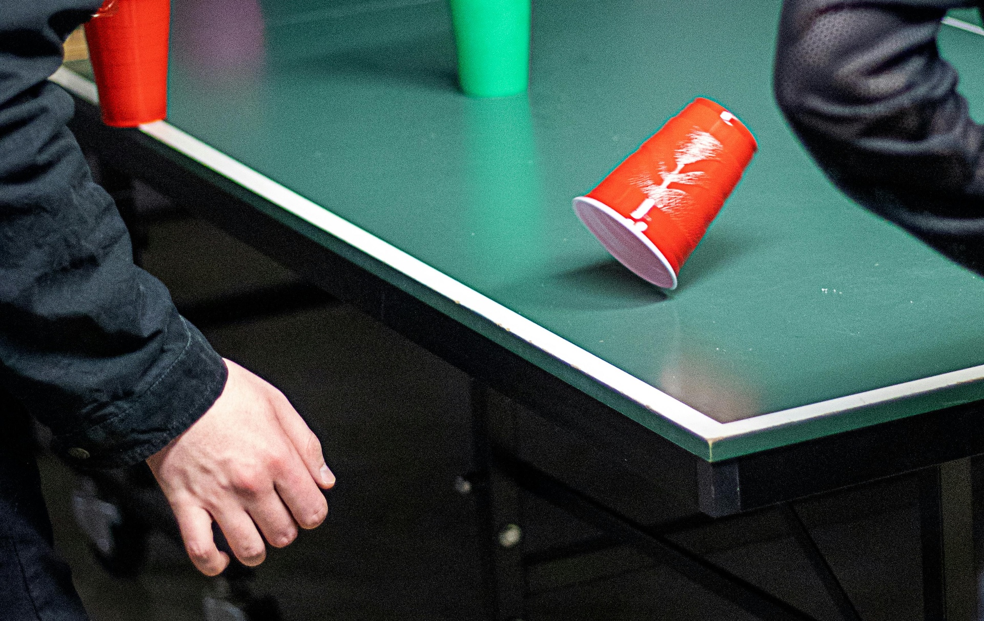 man playing flip cup drinking game