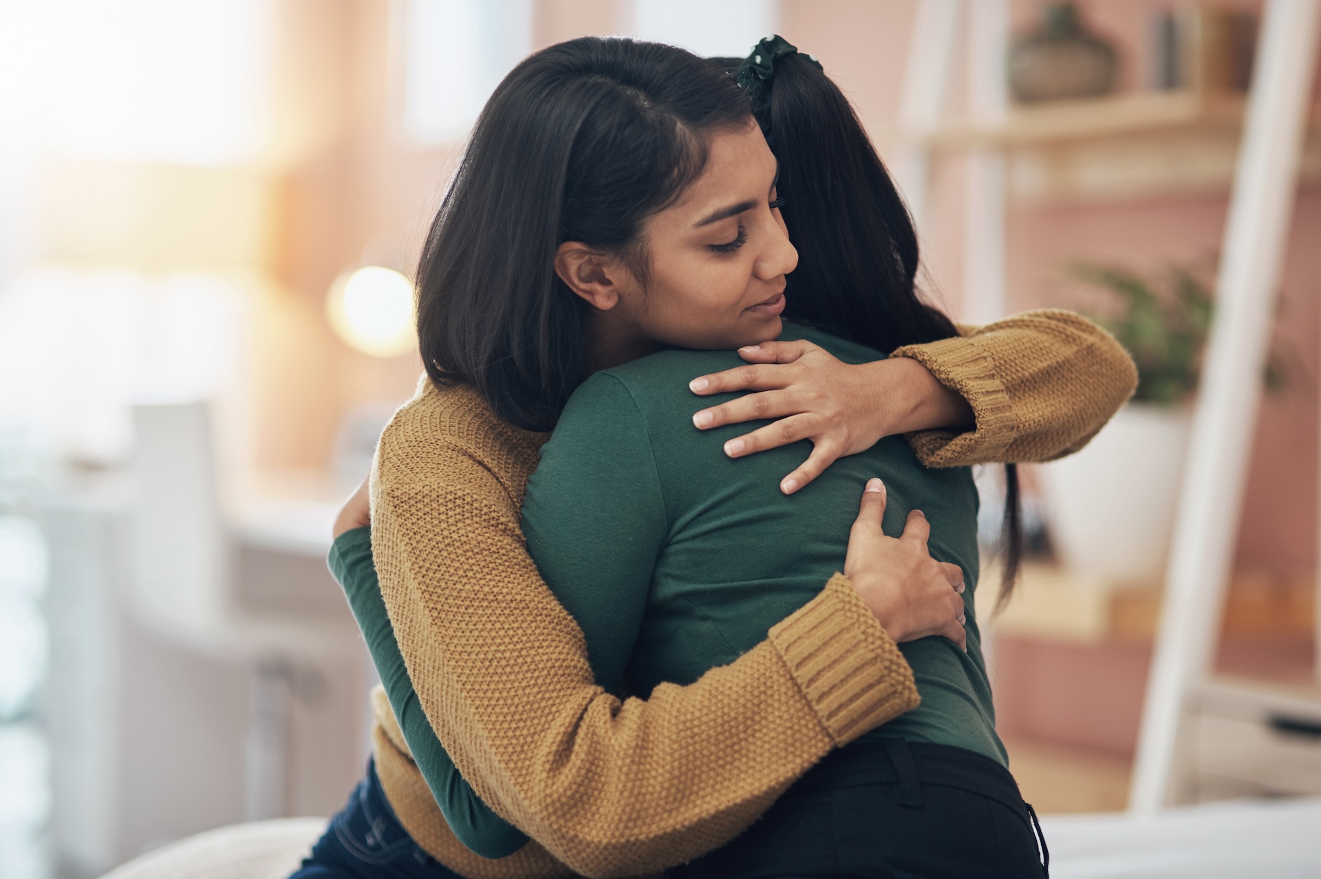 two young women embracing each other at a celebration of life event