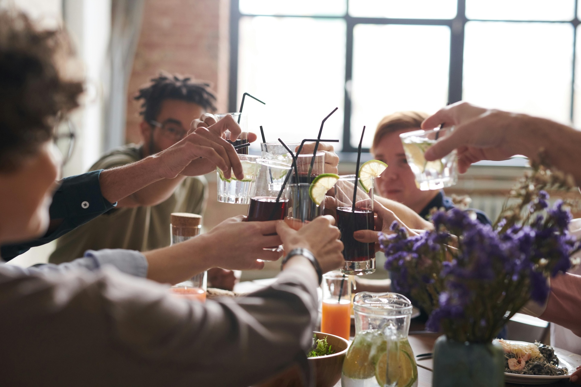 friends toasting with fruity drinks