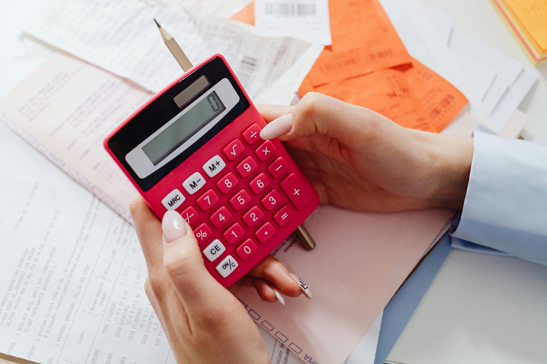 a person using a calculator for one of the functions of financial management