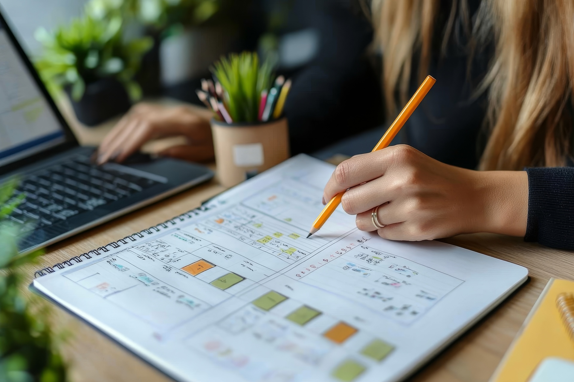 woman hand writing with pencil planning event on notebook