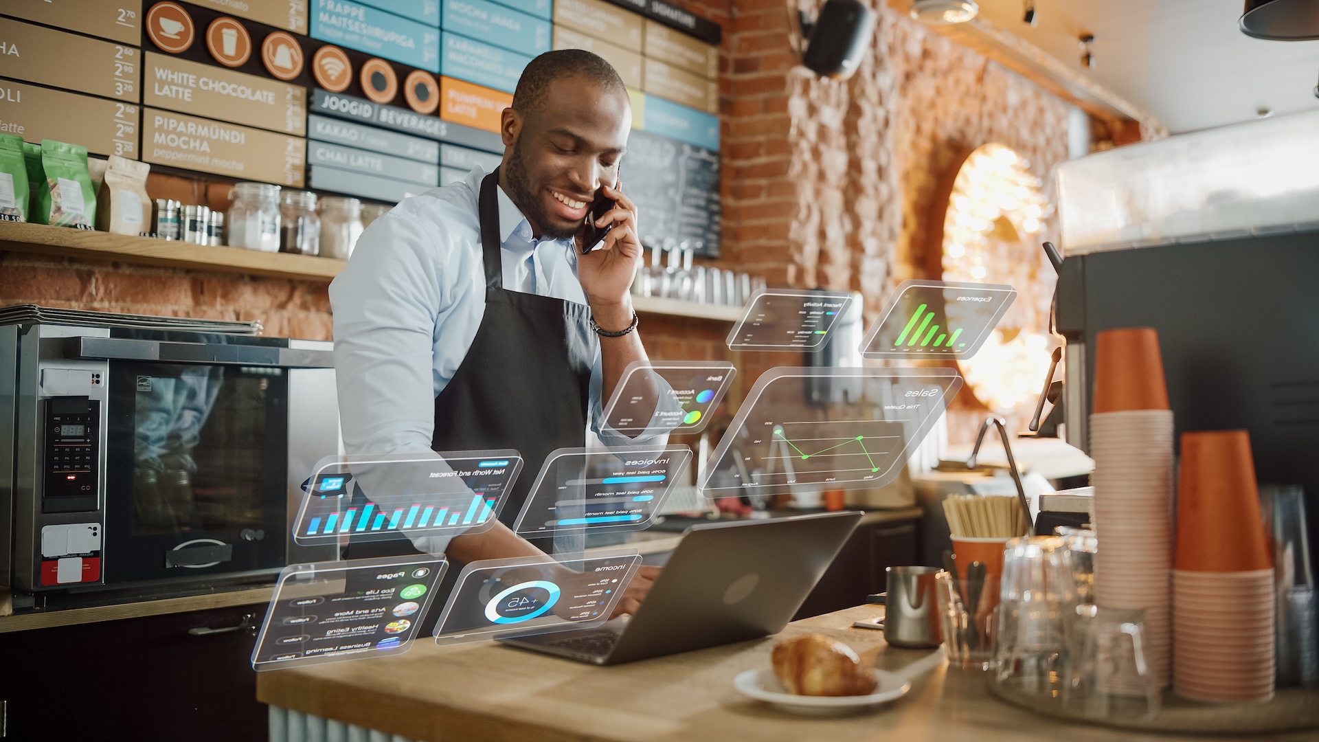 Augmented Reality Icons Popping Out of Restaurant Manager's Laptop