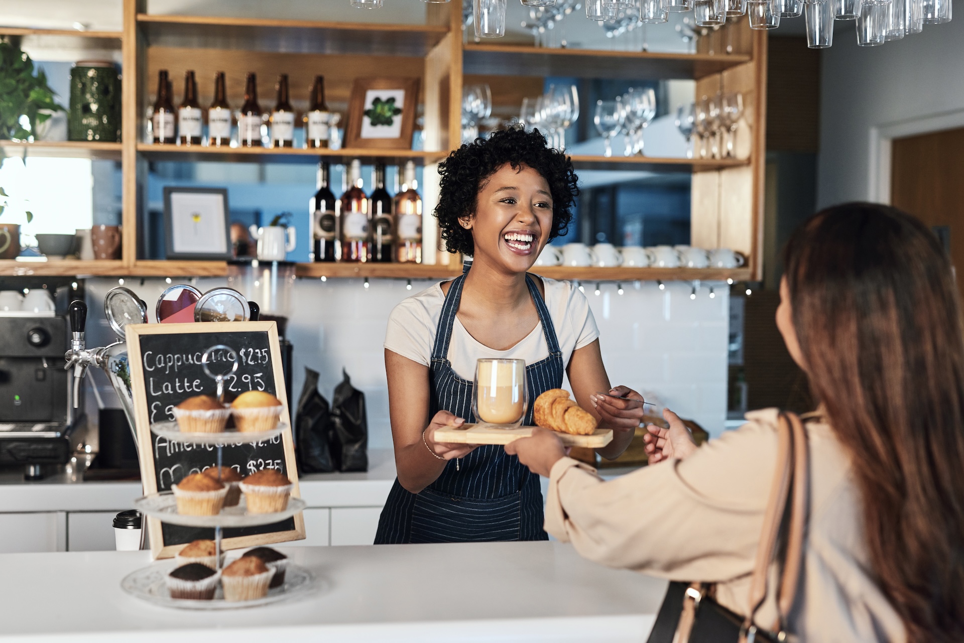 barista serving customer at cafe for service