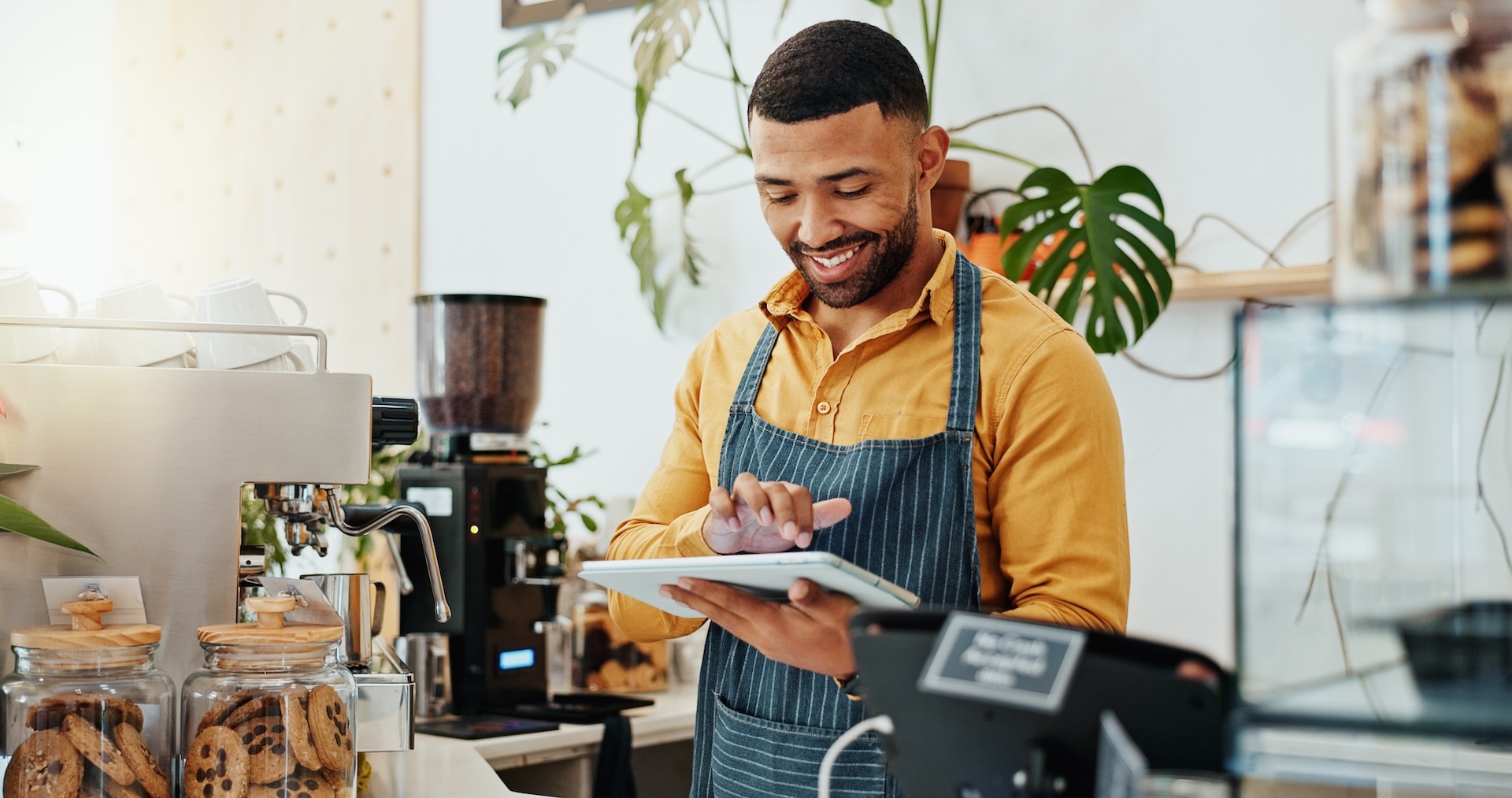Waiter using tablet in coffee shop for restaurant order system