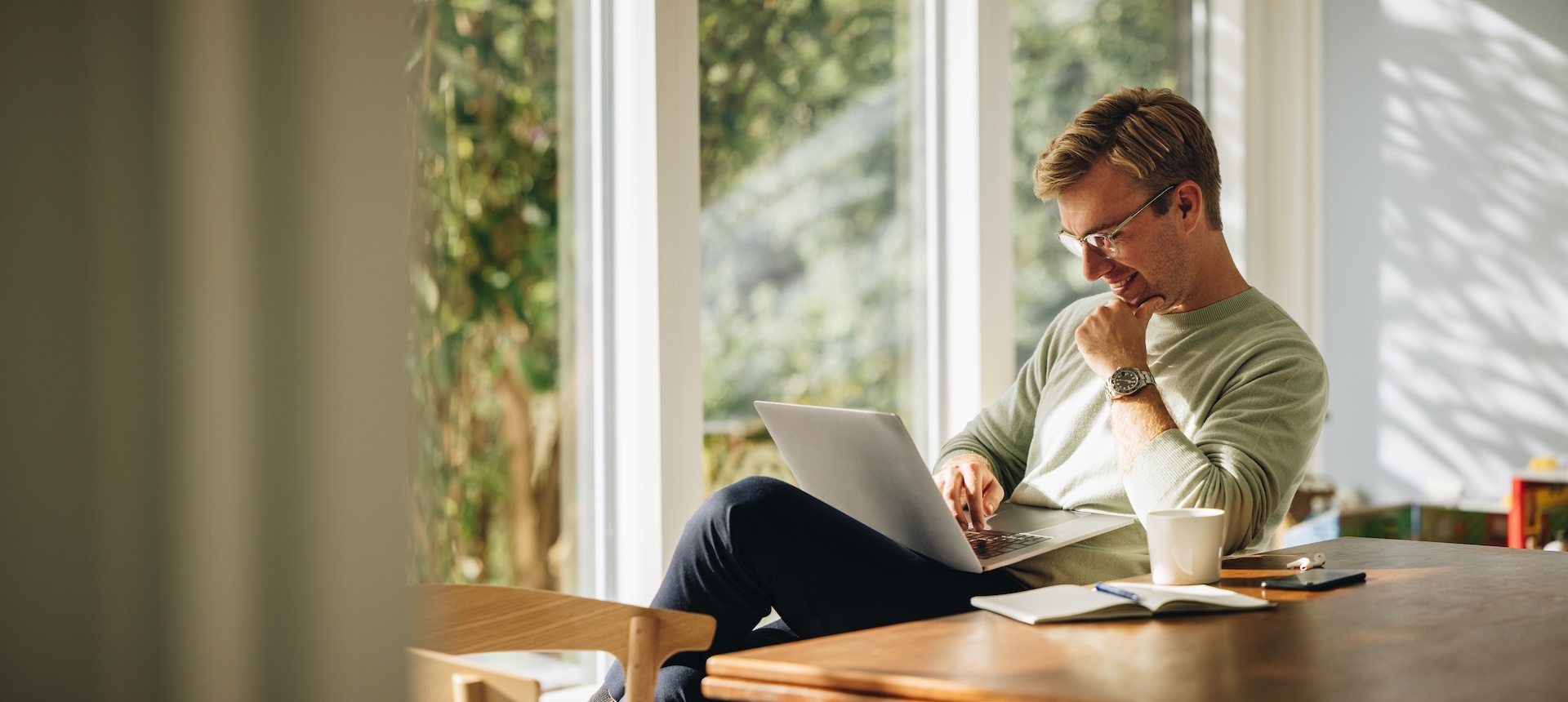restaurant owner looking over courses on laptop and smiling