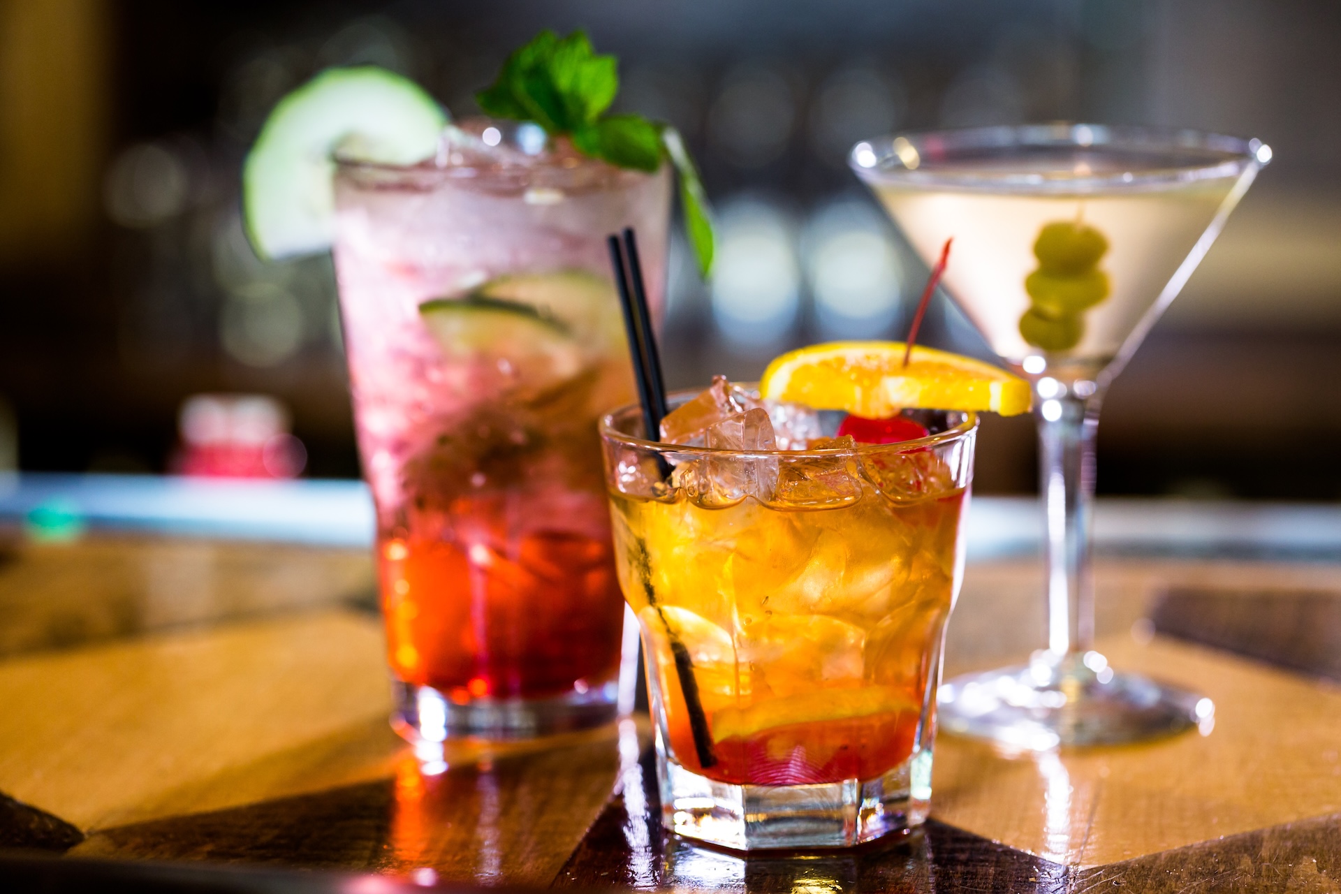 three cocktails at a bar as an event idea