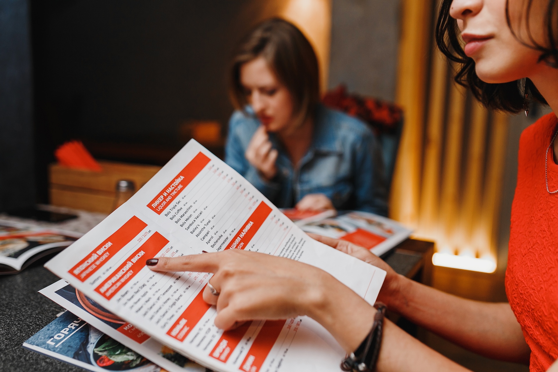 girlfriends in cafe night club choose the food menu