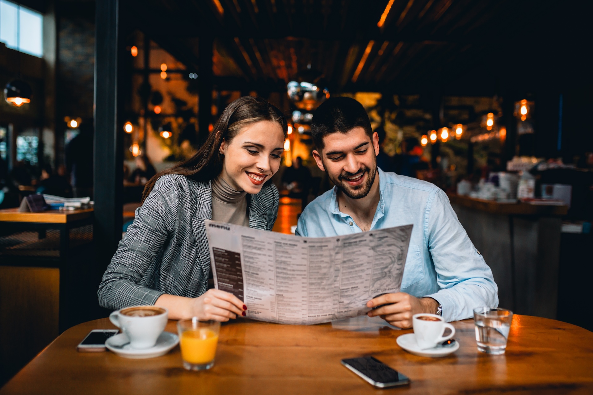 friends in bar looking at menu