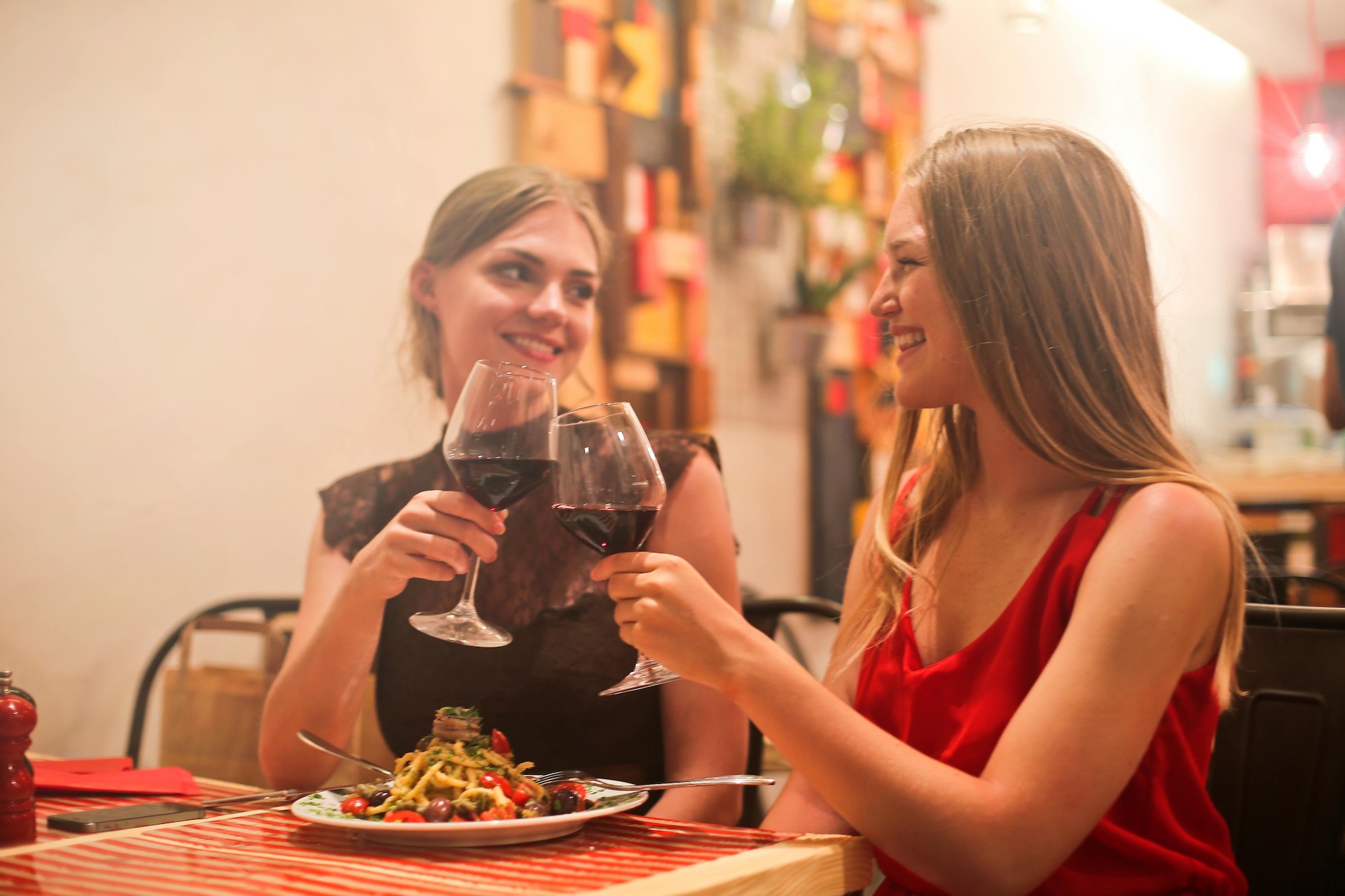 two woman drinking wine