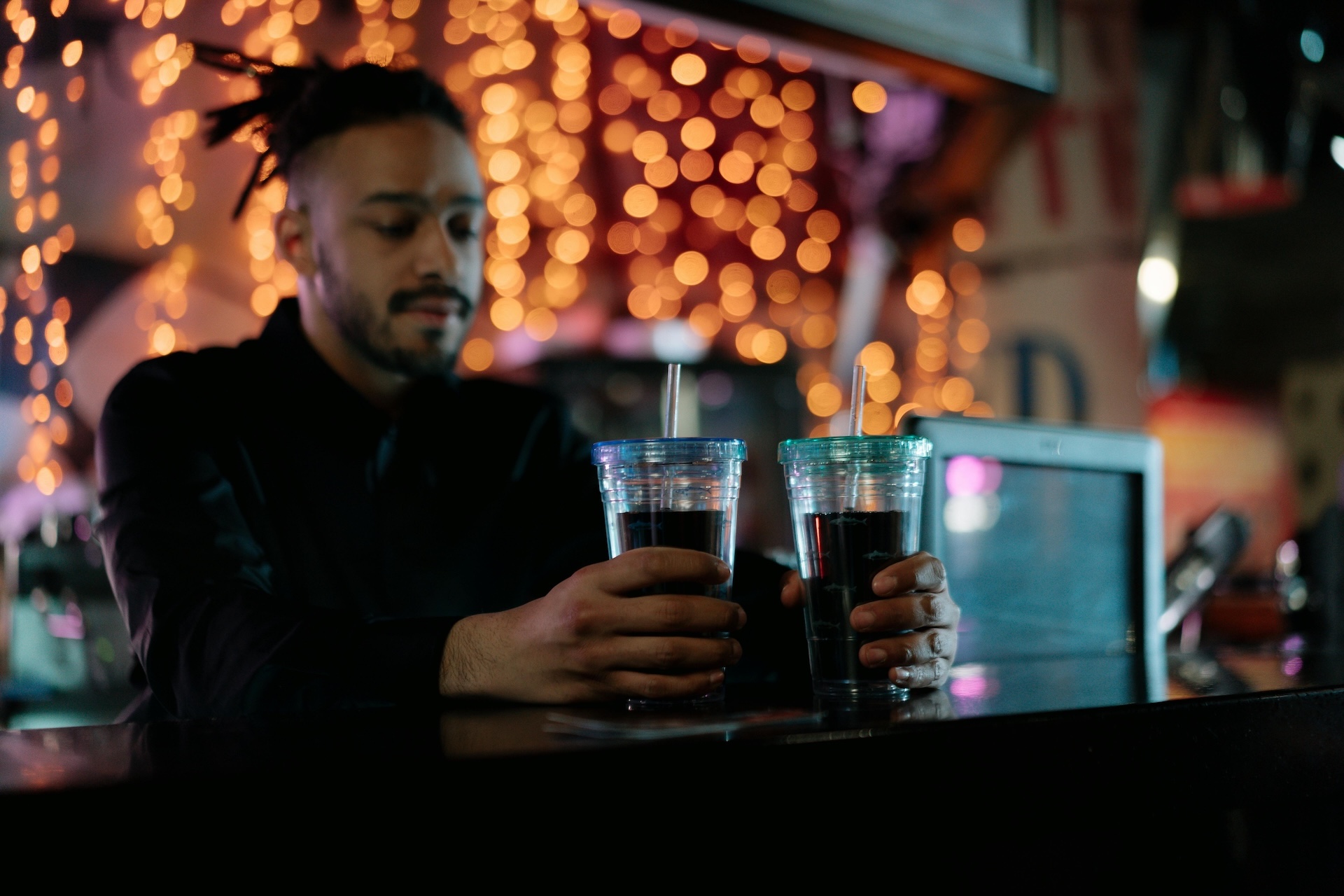 bartender at event holding two drinks