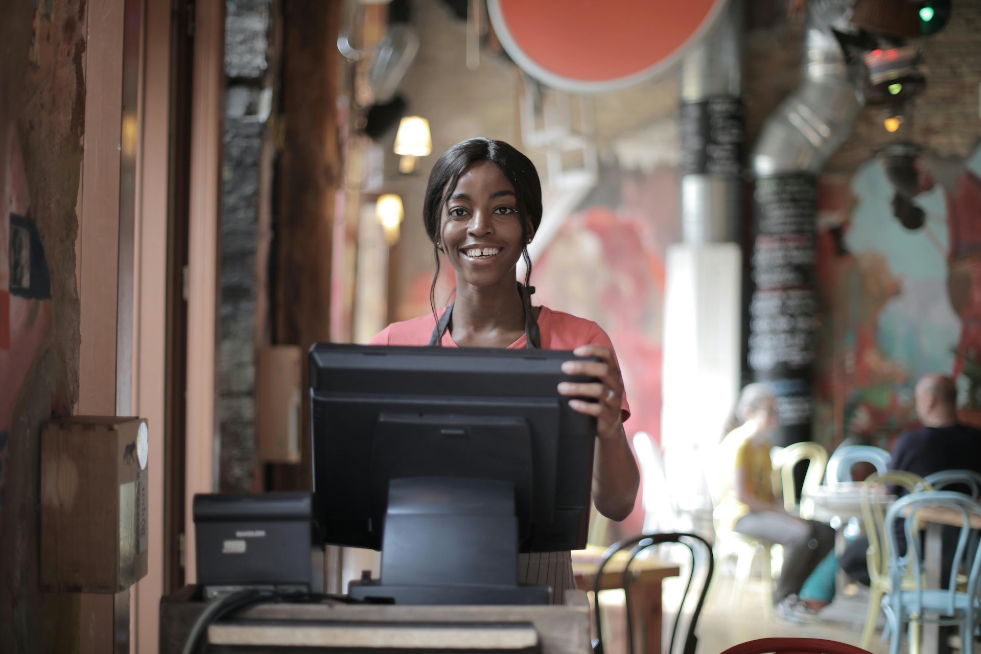 cheerful waitress infront of restaurant